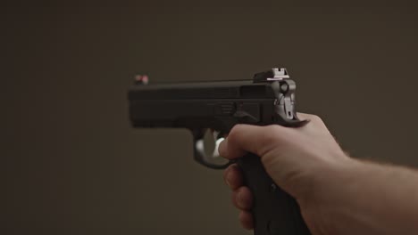 Single-hand-gently-lowering-9mm-handgun