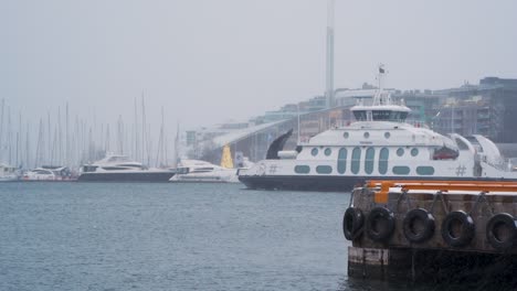 Passenger-Ship-Dronningen-Seen-Departing-Harbour-At-Aker-Brygge-On-Overcast-Snowy-Day-In-Oslo
