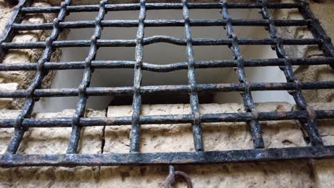 Metal-Grid-Closure-Of-A-Hole-In-Ancient-Belem-Tower-In-Lisbon,-Portugal