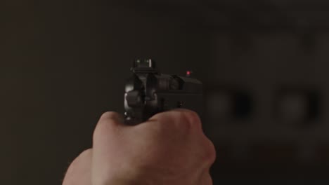 close-up-of-pistol-being-aimed-on-shooting-range