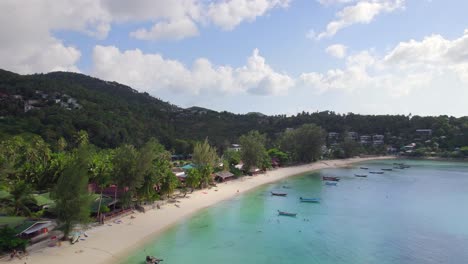 4k-Aerial-Drone-Footage-Orbit-Shot-of-Salad-Beach-on-Koh-Phangan-in-Thailand-with-Fishing-Boats,-Teal-Water,-Coral,-and-Green-Jungles