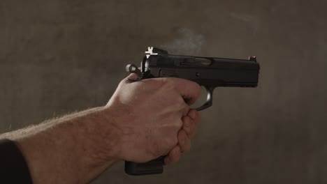 Male-hand-firing-9mm-handgun