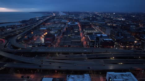 cinematic-aerial-of-downtown-Milwaukee,-Wisconsin,-USA-at-night-time-towards-sunrise