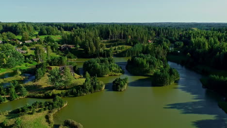 Lake-flatlands-with-forest-and-luxury-architecture,-aerial-drone-view