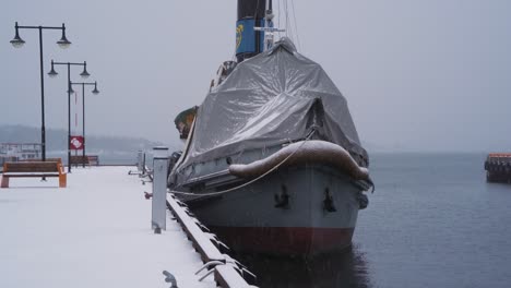 Moored-Boat-With-Covered-Forward-Bow-Tied-To-Pier-Dock-At-Aker-Brygge-In-Winter