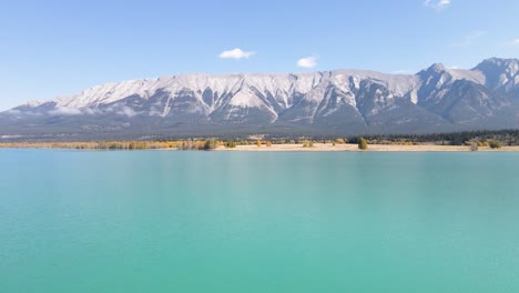 Flying-Low-Above-Turquoise-Color-Water-In-Alberta