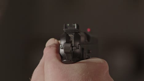 Rear-of-9mm-pistol-being-aimed-at-something-off-screen