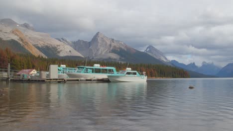 Tourism-boats-docked-on-stunning-glacial-water-lake-surrounded-by-the-Canadian-rocky-mountains