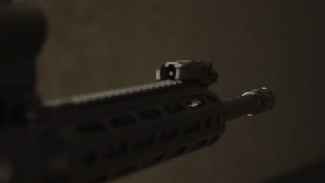 Close-up-of-AR15-assault-rifle-barrel-being-aimed-at-something-off-screen