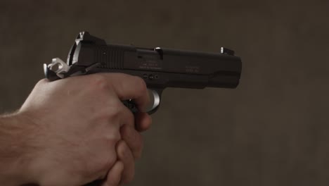 Close-up-of-small-caliber-pistol-being-held-by-Caucasian-man