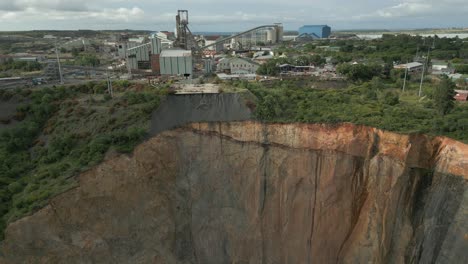 Low-aerial-view-of-dangerous-scaling-erosion-of-open-pit-mine-wall