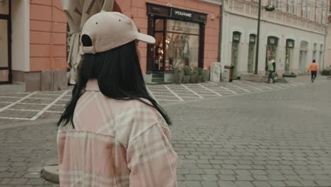 Side-Portrait-Of-A-Cool-Girl-In-Cap-Walking-In-The-City-Of-Brasov-In-Romania