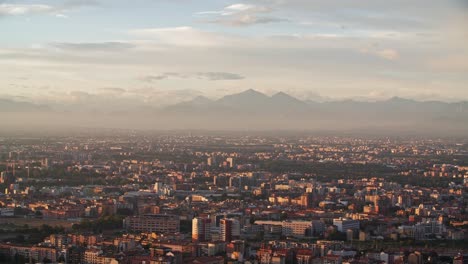 Foggy-Grigne-mountains-and-Milan-cityscape,-view-from-above