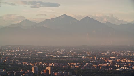 Foggy-Gringe-Mountain-with-Milan-cityscape,-view-from-above