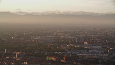 Milan-suburbs,-Lombardy-and-foggy-mountain-range-in-horizon,-view-from-above