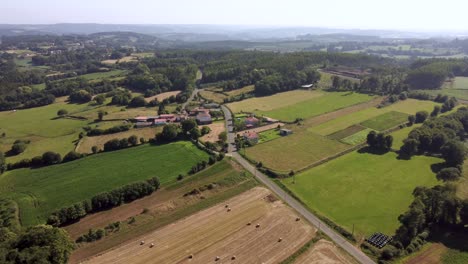 Vastness-Of-Rural-Landscape-With-Isolated-Village-Near-Farmland-During-Harvest-Season