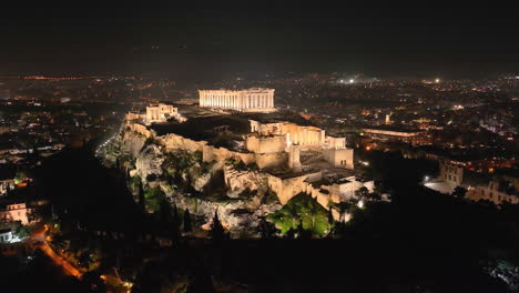 Drone-flight-around-the-Acropolis-of-Athens,-Greece-at-night