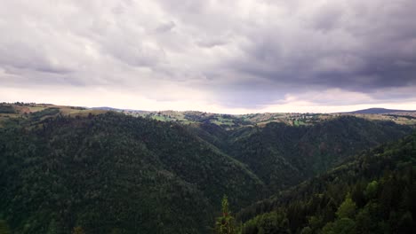 Aerial-view-of-carpathian-mountain-valley-with-green-forest-in-Marisel