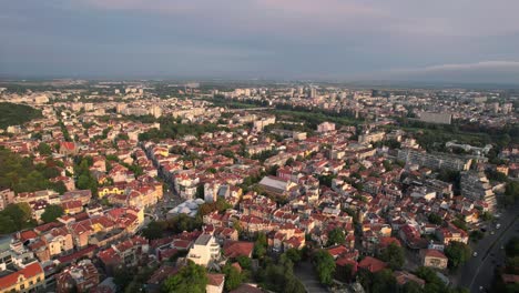 Establisher-aerial-of-city-of-Plovdiv-in-Bulgaria,-cityscape-rooftops,-day