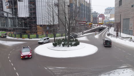 Cars-drive-around-a-roundabout-in-a-city-at-winter