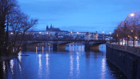 Blue-hour-distant-view-of-Prague-castle-with-bridge-in-the-foreground-during-early-morning