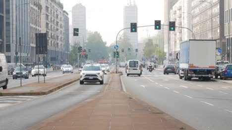 Breite-Straße-Von-Mailand-In-Der-Innenstadt-Mit-Fahrenden-Autos,-Handheld-Ansicht