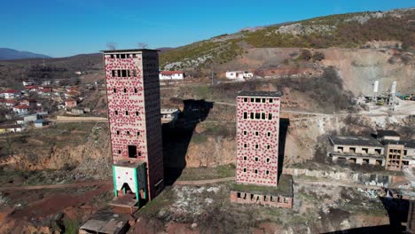 Ruined-factory-with-high-cement-towers-and-bricks-buildings-remained-from-communist-era-in-Albania