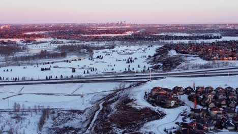 Aerial-shots-of-Calgary's-snow-covered-mountains-during-a-beautiful-winter-sunrise