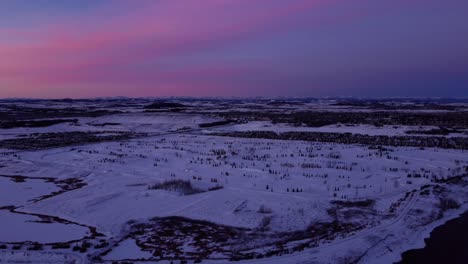 Flying-a-drone-in-Calgary-during-a-stunning-pink-winter-sunrise-and-mountains-on-background