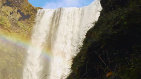Large-Waterfall-With-A-Rainbow-Going-Across-It-During-Daytime