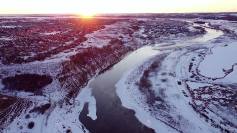Flying-drone-in-Calgary-during-a-beautiful-winter-sunrise-with-god-rays