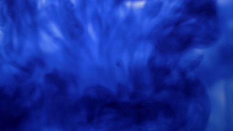 Colored-smoke-on-a-white-background,-colored-paint-spills-on-a-transparent-liquid,-drop-of-blue-ink-falling-in-water,-Drops-of-watercolor-paint