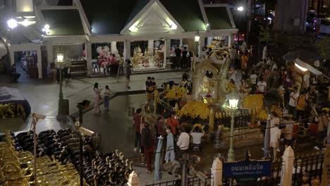 Erawan-Shrine-at-night-when-people-praying-for-good-fortune,-view-from-skywalk