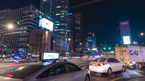 Night-Cars-Traffic-Timelapse-at-Gwanghwamun-Station-Crossroads-and-People-Crossing-Road-on-Crosswalk