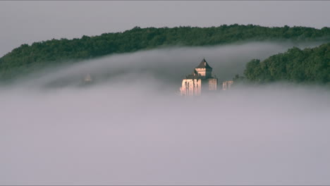 Timelpase-of-Castelnaud-Castle-in-the-clouds-early-in-the-morning,-France---Dordogne