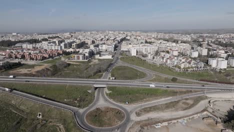Altamura,-Italy-skyline-with-highway-and-traffic-with-drone-video-pulling-out