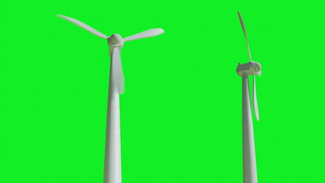 A-looping-video-of-turning-wind-turbines-on-green-background-from-a-low-angle