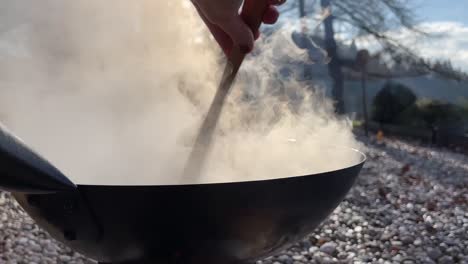 Cooking-in-a-wok-over-an-open-fire