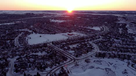 Aerial-shots-of-Calgary's-sunrise-over-the-mountains-in-winter
