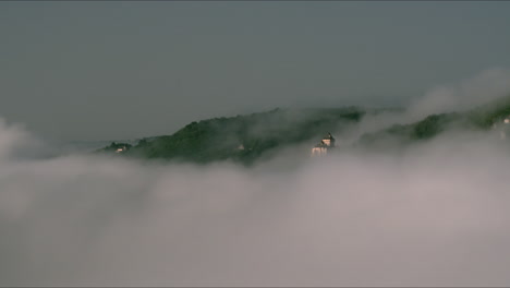 Wide-valley-with-Castelnaud-Castle-in-the-clouds-early-in-the-morning,-France---Dordogne