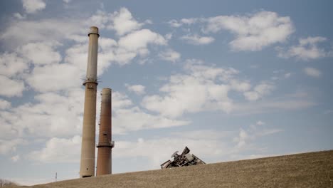 coal-fired-power-plant-smoke-stacks-sit-against-a-blue-sky-with-scattered-clouds