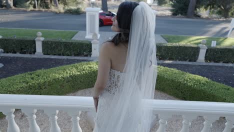 Young-bride-looking-over-her-shoulder-as-she-is-photographed