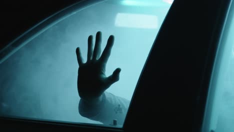 Creepy-hand-by-night.-Horror-scene-in-car