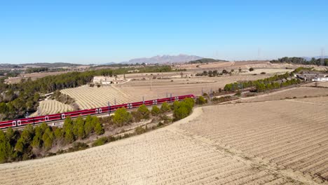 Aerial:-high-speed-red-train-in-Spain-between-Barcelona-and-Madrid-among-vineyards
