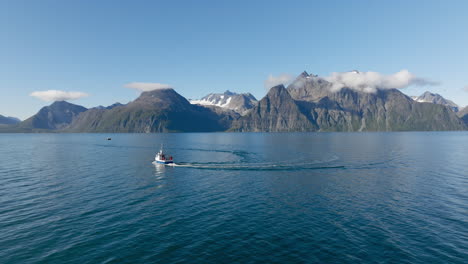 Fischerboot-Segelt-Auf-Blauem-Meerwasser-Des-Lyngenfjords-Mit-Felsigen-Bergen-Der-Skandinavischen-Alpen-Im-Hintergrund-An-Einem-Sonnigen-Tag,-Norwegen