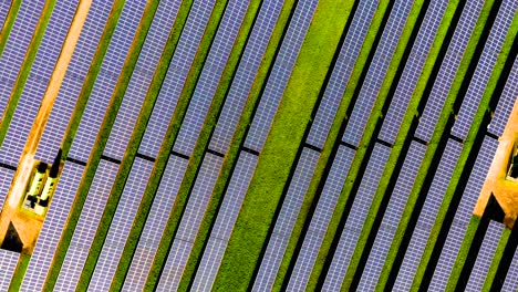 Descending-rotating-aerial-view-of-a-large-solar-farm,-Cambridgeshire,-UK