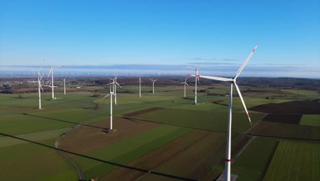 Harnessing-the-Power-of-the-Wind:-Aerial-View-of-Wind-Turbines-Generating-Renewable-Energy-on-a-Sunny-Day-in-Brilon,-Sauerland,-Germany