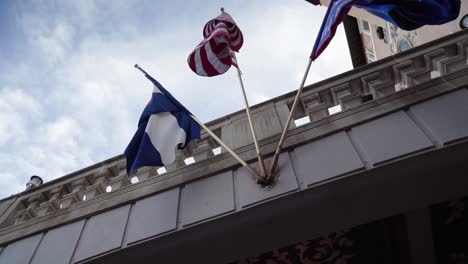 Low-angle-stabilized-shot-of-international-flags-at-a-hotel-entrance