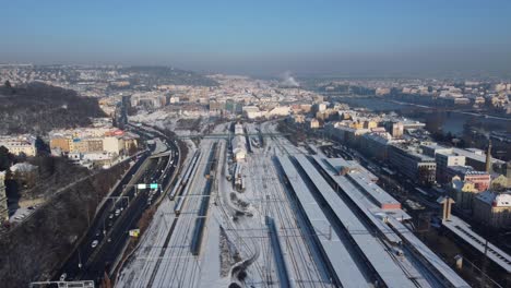 Smichov-railway-station-in-Prague,-Czech-Republic,-aerial-drone-view,-winter-sunny-day,-side-flight