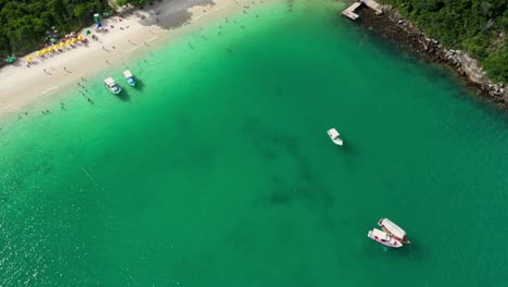Birds-eye-view-of-gorgeous-green-water-sea-and-beach-secluded-within-Brazilian-jungle